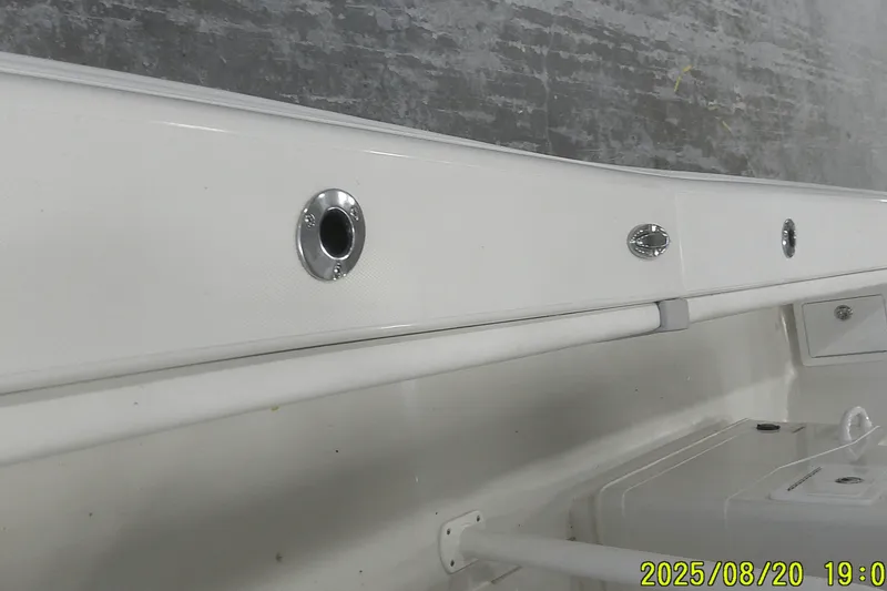 Slide: The Image of 2024 Ranger 2600 Bay boat interior detail with rod holders and storage compartments. - 23
