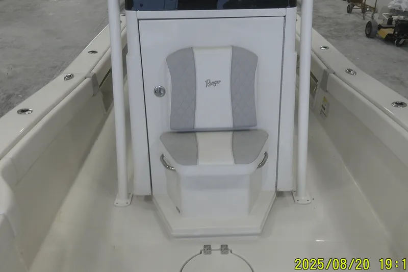 Slide: The Image of 2024 Ranger 2600 Bay boat interior with cushioned seat and storage compartment. - 25