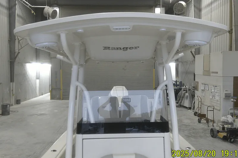 Slide: The Image of 2024 Ranger 2600 Bay boat in a warehouse, viewed from the front. - 26