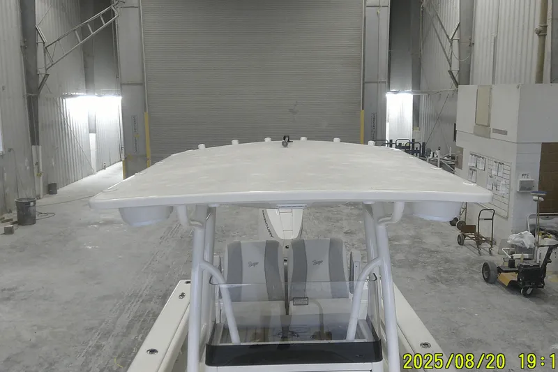 Slide: The Image of 2024 Ranger 2600 Bay boat in a warehouse setting, viewed from above. - 27