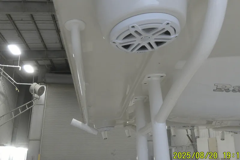 Slide: The Image of 2024 Ranger 2600 Bay boat underside with speaker, in a warehouse setting. - 29