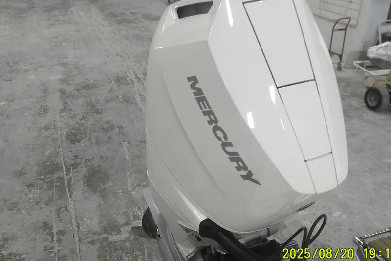 Slide: The Image of 2024 Ranger 2600 Bay boat with Mercury outboard motor in a workshop setting. - 3