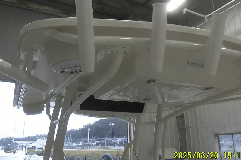 Slide: The Image of 2024 Ranger 2600 Bay boat interior, featuring rod holders and speaker system. - 31