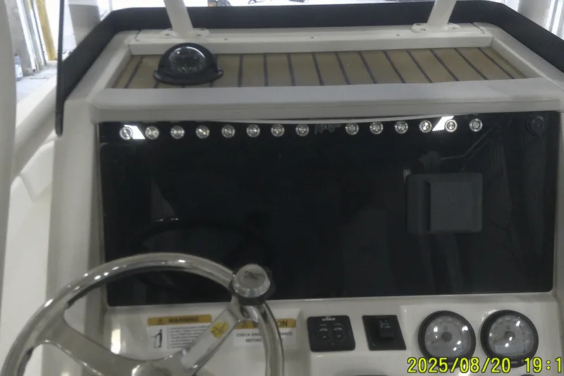 Slide: The Image of 2024 Ranger 2600 Bay boat dashboard with steering wheel and gauges. - 36