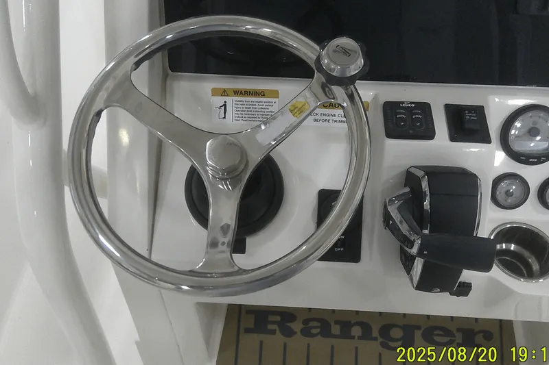 Slide: The Image of 2024 Ranger 2600 Bay boat dashboard with steering wheel and controls. - 37