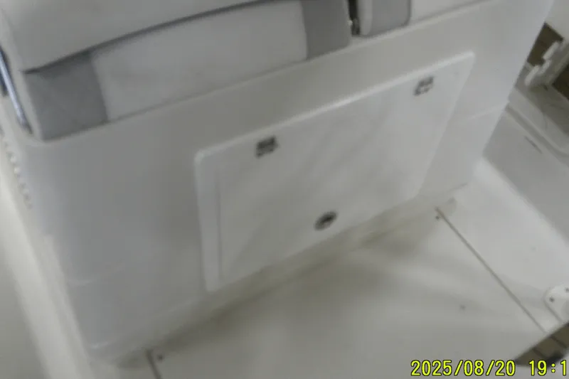 Slide: The Image of 2024 Ranger 2600 Bay boat interior with storage compartment, white seating, and clean design. - 39