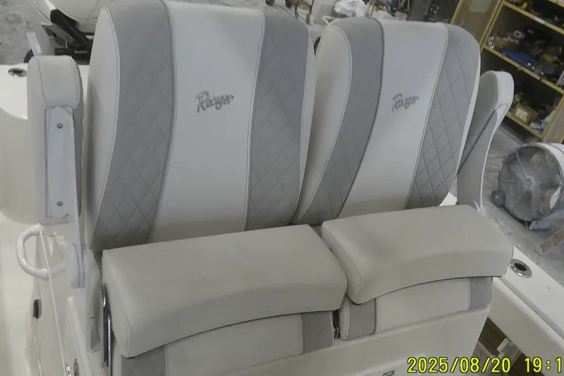 Slide: The Image of 2024 Ranger 2600 Bay boat seats with gray and white diamond pattern upholstery. - 41