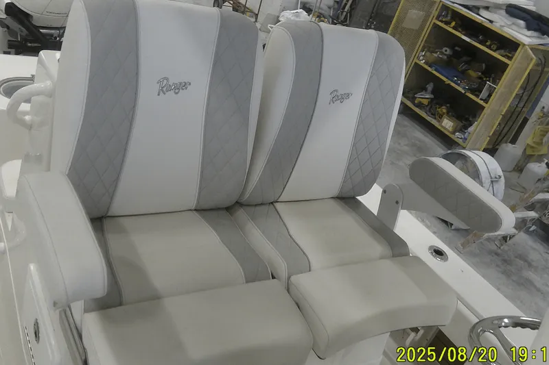 Slide: The Image of 2024 Ranger 2600 Bay boat seats with diamond stitching in a workshop setting. - 42