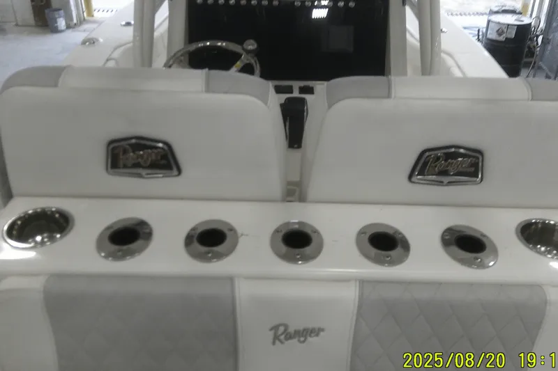 Slide: The Image of 2024 Ranger 2600 Bay boat interior with cup holders and branded seats. - 43