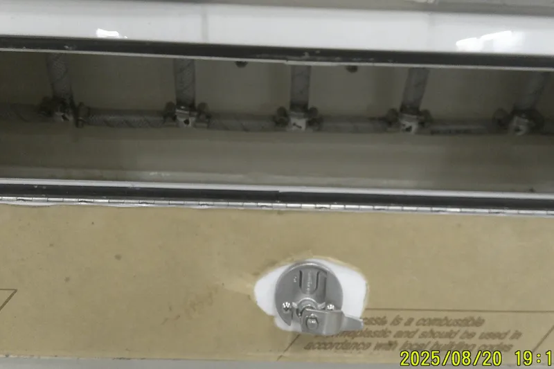 Slide: The Image of 2024 Ranger 2600 Bay boat interior detail with visible wiring and latch mechanism. - 45