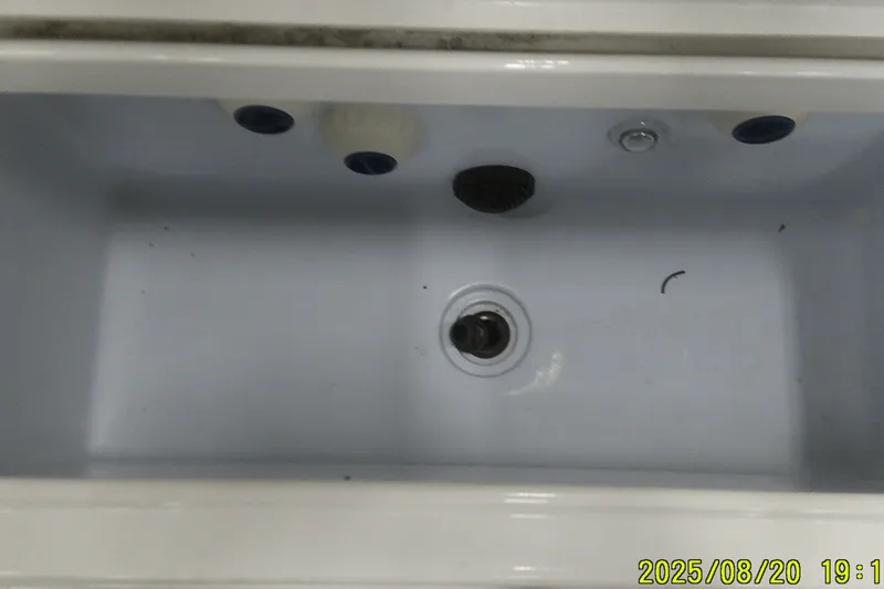 Slide: The Image of 2024 Ranger 2600 Bay boat livewell interior, empty and clean. - 47