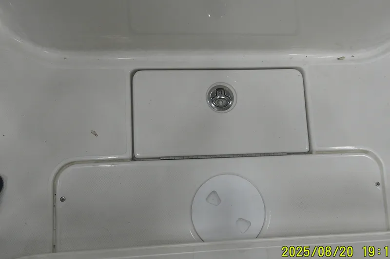 Slide: The Image of 2024 Ranger 2600 Bay boat deck with storage compartment and latch. - 48