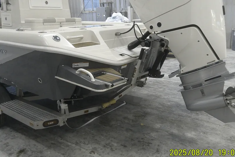 Slide: The Image of 2024 Ranger 2600 Bay boat with outboard motor on trailer in a garage setting. - 5