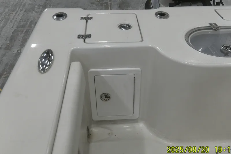 Slide: The Image of 2024 Ranger 2600 Bay boat interior with storage compartment and fixtures. - 53