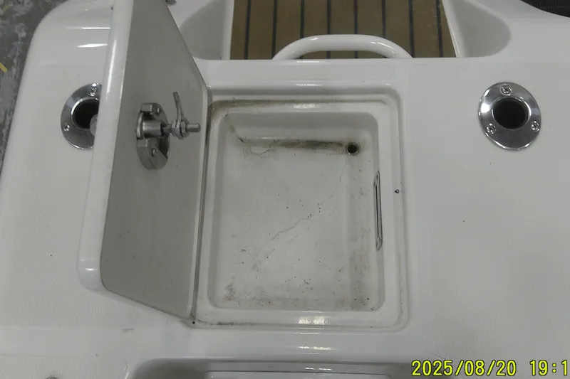 Slide: The Image of Open storage compartment on 2024 Ranger 2600 Bay boat deck. - 55