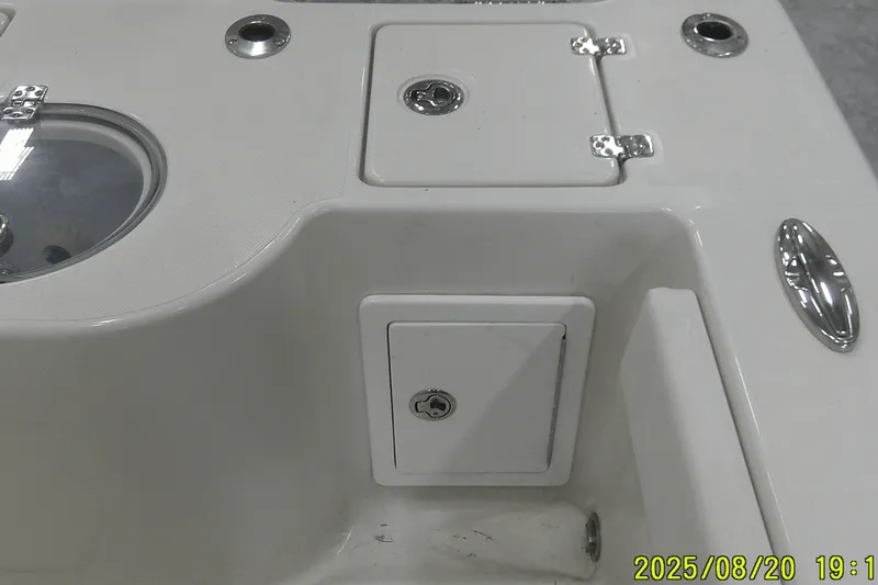 Slide: The Image of 2024 Ranger 2600 Bay boat deck with storage compartments and fixtures. - 56