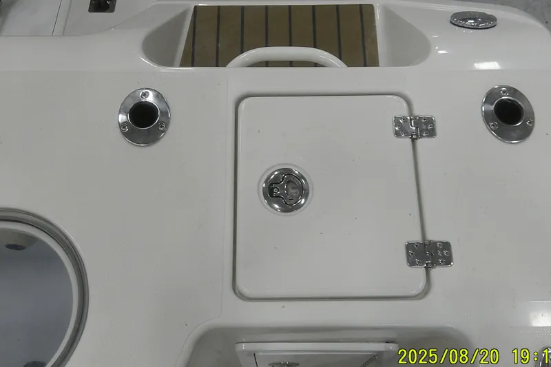 Slide: The Image of 2024 Ranger 2600 Bay boat deck with storage hatch and rod holders. - 58