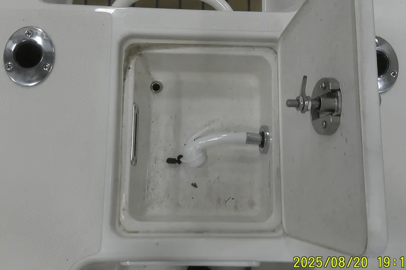 Slide: The Image of Open compartment on 2024 Ranger 2600 Bay boat with visible plumbing and fittings. - 59