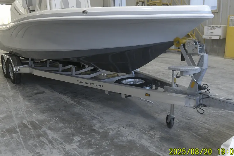 Slide: The Image of 2024 Ranger 2600 Bay boat on trailer in a warehouse setting. - 6