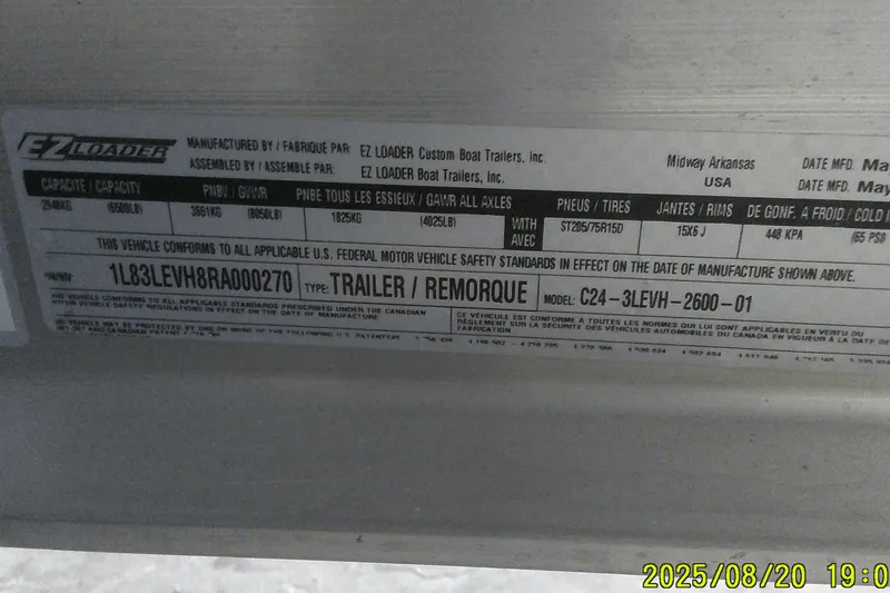 Slide: The Image of Label on EZ Loader trailer, model C24-3LEVH-2600-01, showing specifications and compliance details. - 62