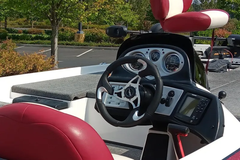 Slide: The Image of 2009 Skeeter ZX190 boat dashboard with steering wheel and gauges, featuring red and white seating. - 3