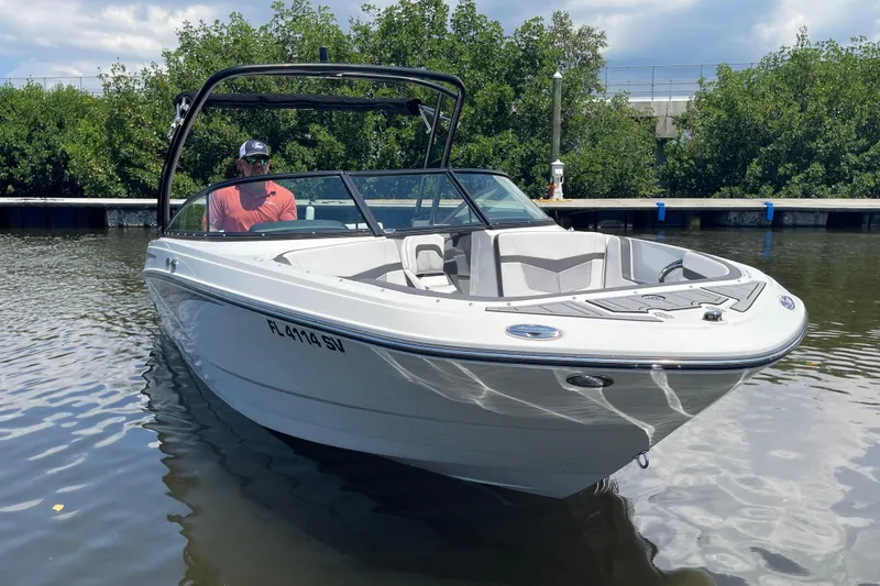Slide: The Image of 2021 Monterey M225 boat on calm water with lush greenery background. - 11