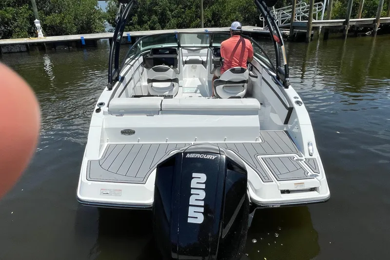 Slide: The Image of 2021 Monterey M225 boat with Mercury engine, docked on calm water. - 19