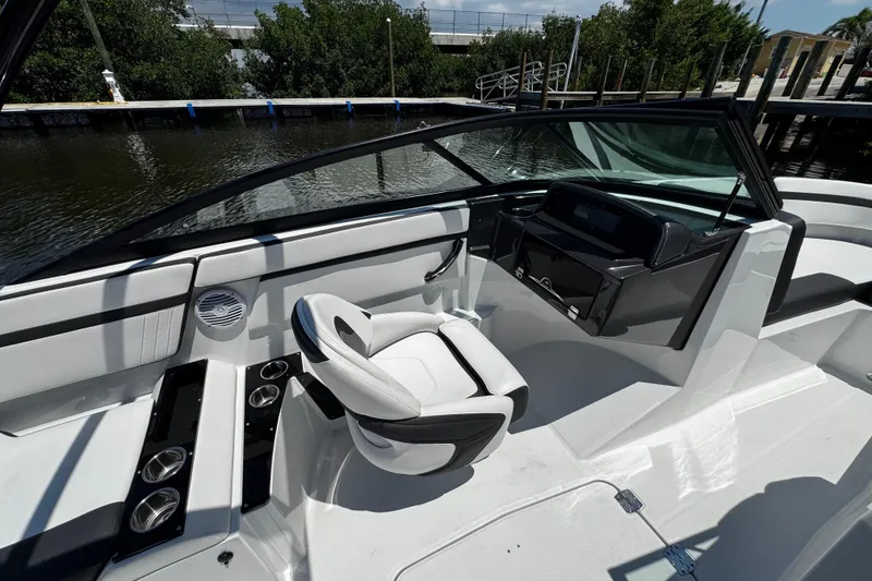 Slide: The Image of 2021 Monterey M225 boat interior with sleek seating and modern dashboard design. - 23