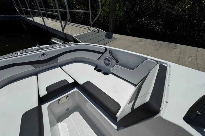 Slide: The Image of 2021 Monterey M225 boat interior with cushioned seating and storage compartment. - 27
