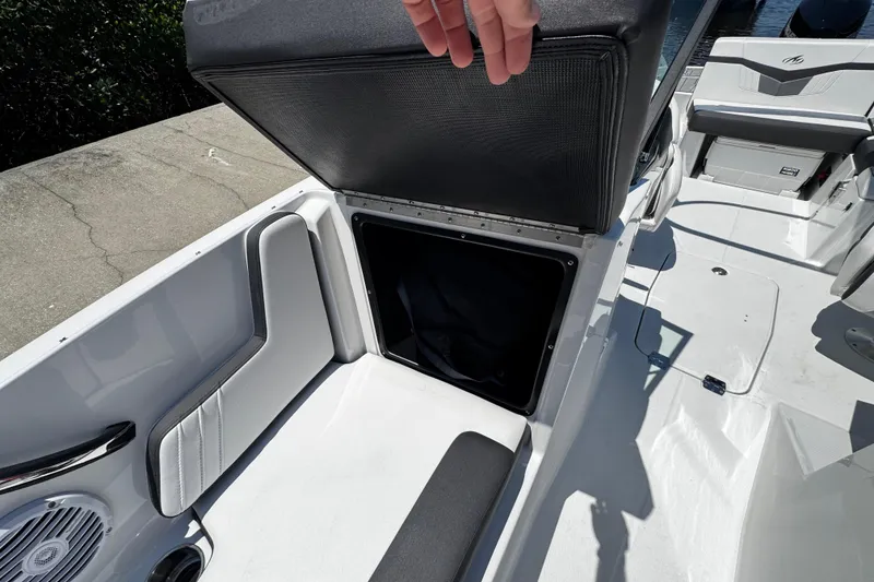 Slide: The Image of 2021 Monterey M225 boat storage compartment with open seat, showcasing interior space. - 29