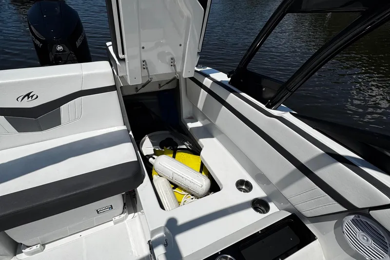 Slide: The Image of Interior of a 2021 Monterey M225 boat with seating and storage compartments. - 32