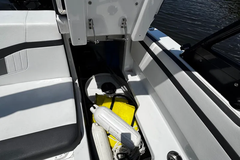 Slide: The Image of 2021 Monterey M225 boat storage compartment with safety equipment and accessories. - 33