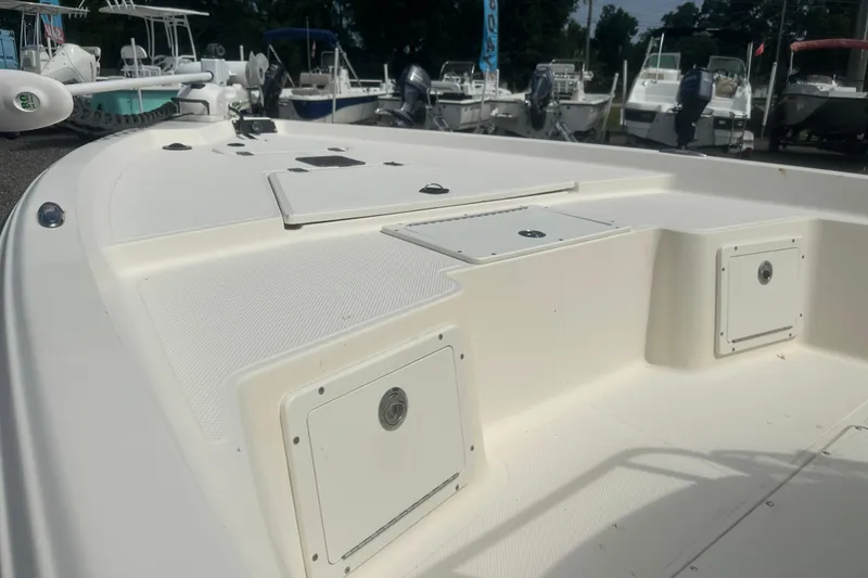 Slide: The Image of 2003 Key West 196 Bay Reef boat deck with storage compartments, displayed outdoors. - 12