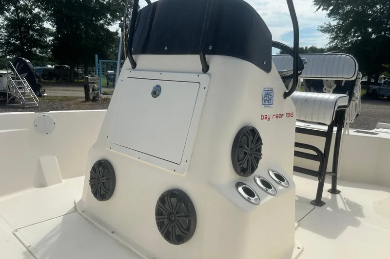 Slide: The Image of 2003 Key West 196 Bay Reef boat console with speakers and seating. - 13