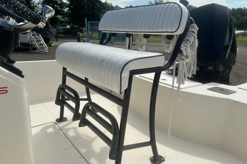 Slide: The Image of 2003 Key West 196 Bay Reef boat with white cushioned seating and black frame. - 14