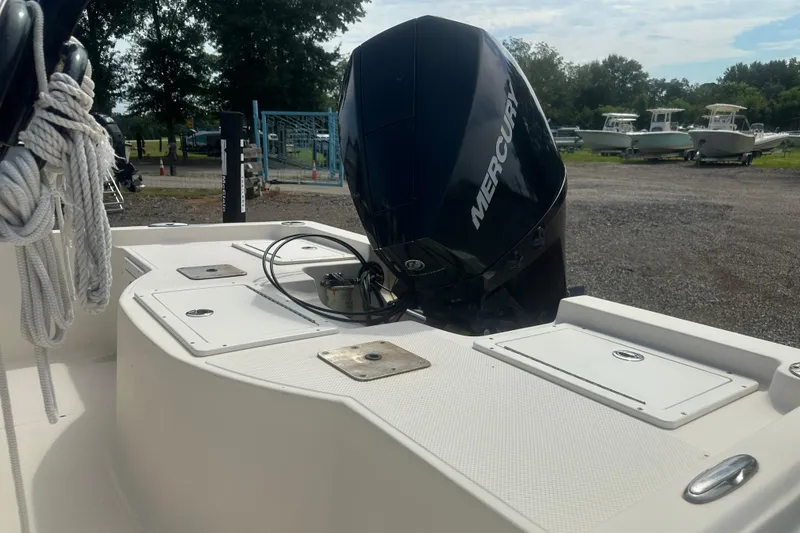 Slide: The Image of 2003 Key West 196 Bay Reef boat with Mercury outboard motor in a marina setting. - 15
