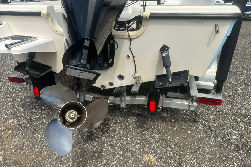Slide: The Image of Rear view of a 2003 Key West 196 Bay Reef boat with outboard motor and trailer. - 17
