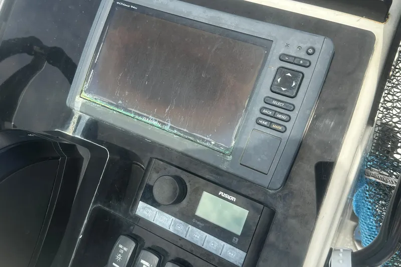 Slide: The Image of Control panel of a 2003 Key West 196 Bay Reef boat with navigation and audio systems. - 18