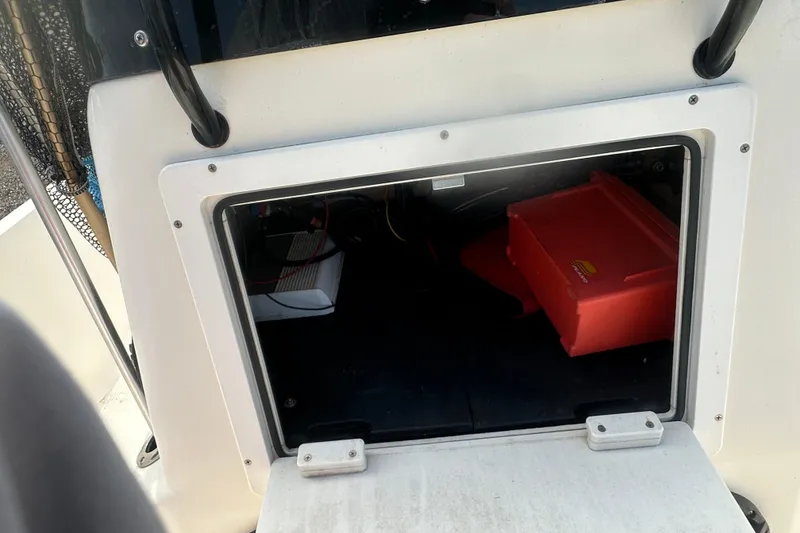 Slide: The Image of Storage compartment of a 2003 Key West 196 Bay Reef boat, featuring a red container. - 21