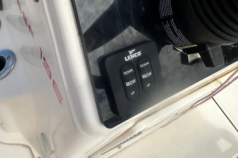 Slide: The Image of Lenco trim tab controls on a 2003 Key West 196 Bay Reef boat dashboard. - 23