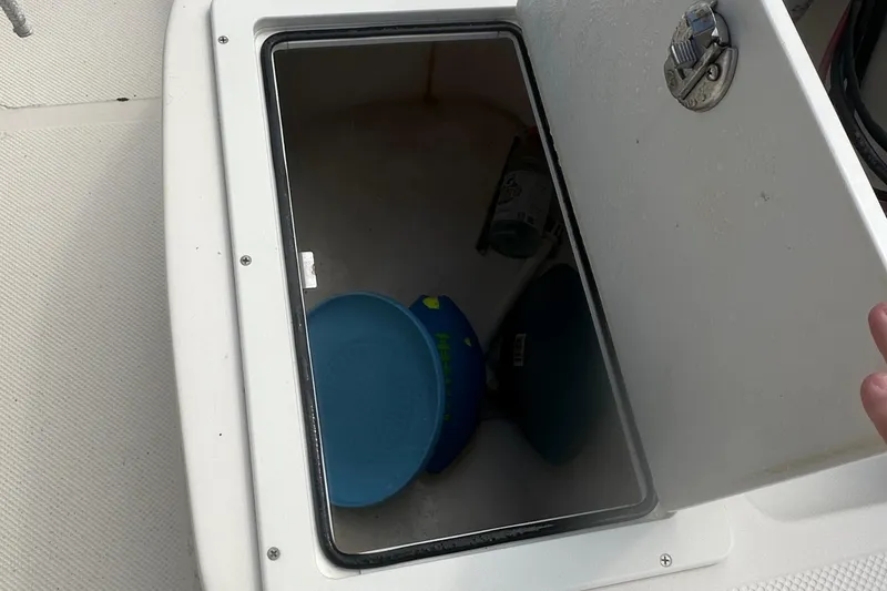 Slide: The Image of Open storage compartment on 2003 Key West 196 Bay Reef boat with items inside. - 24