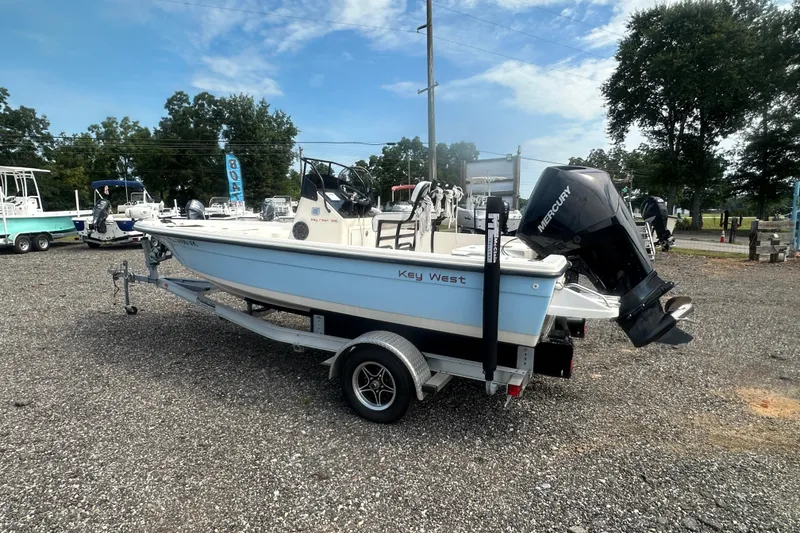 Slide: The Image of 2003 Key West 196 Bay Reef boat on trailer, parked outdoors. - 3