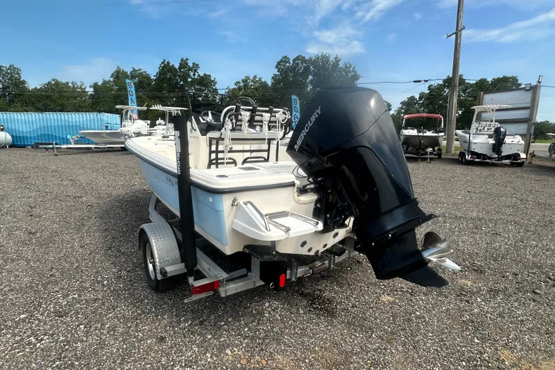 Slide: The Image of 2003 Key West 196 Bay Reef boat with Mercury outboard motor on a trailer. - 4