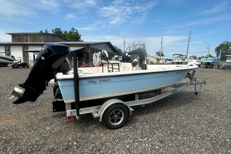 Slide: The Image of 2003 Key West 196 Bay Reef boat on trailer in outdoor lot. - 6