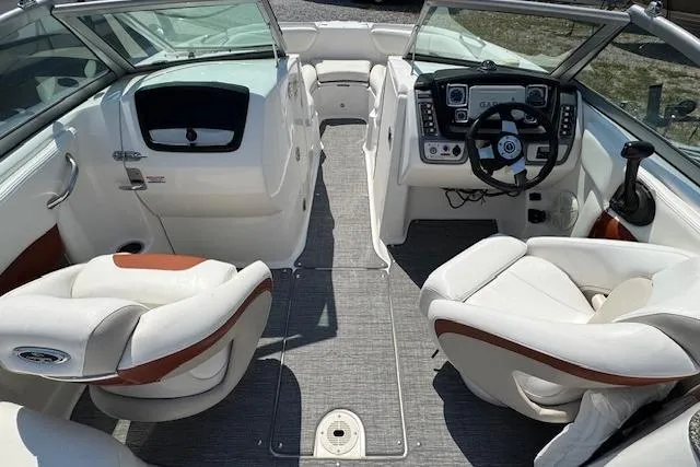 Slide: The Image of 2008 Chaparral Sunesta 224 boat interior with white seating and modern dashboard. - 12