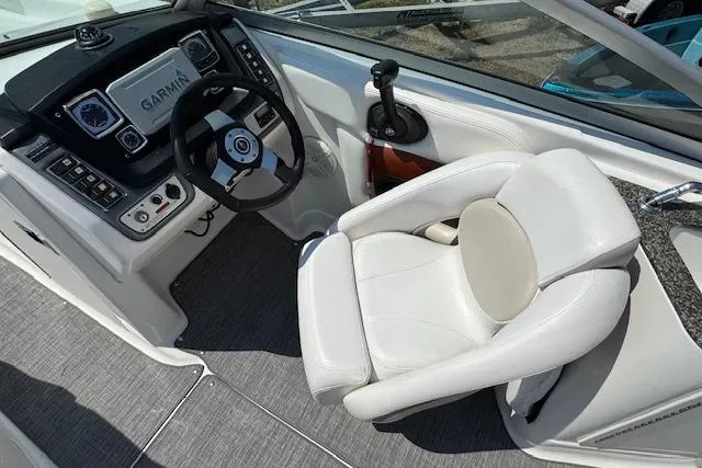 Slide: The Image of 2008 Chaparral Sunesta 224 boat cockpit with Garmin navigation and white captain's chair. - 13