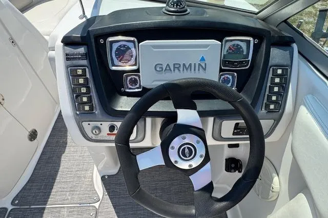 Slide: The Image of 2008 Chaparral Sunesta 224 dashboard with Garmin navigation and steering wheel. - 14