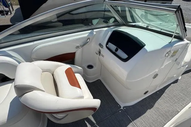 Slide: The Image of 2008 Chaparral Sunesta 224 boat interior with white seating and dashboard. - 15