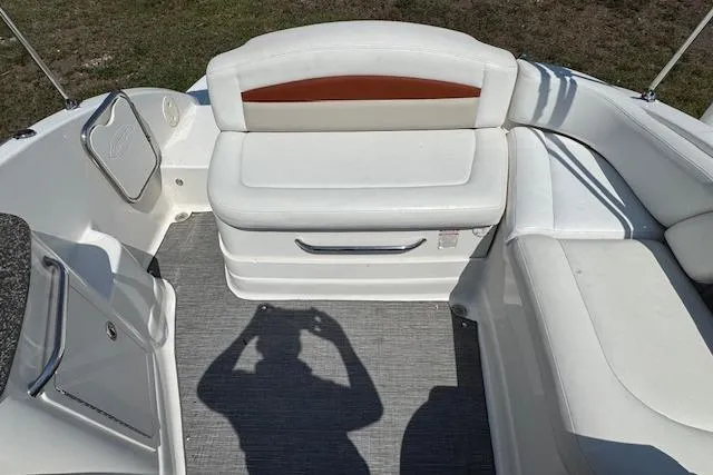 Slide: The Image of 2008 Chaparral Sunesta 224 boat interior with white seating and shadow on deck. - 19
