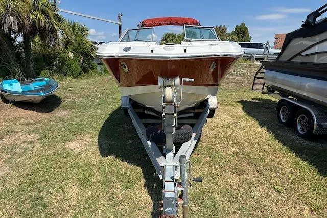 Slide: The Image of 2008 Chaparral Sunesta 224 boat on trailer, parked on grass under clear sky. - 4